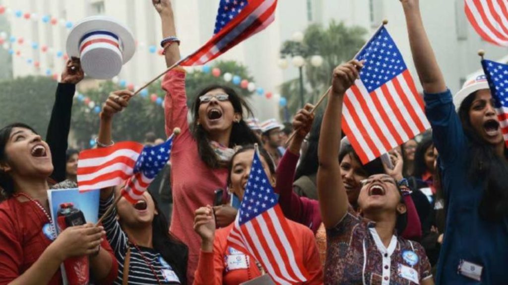 Indian Americans celebrating and waving American flags in US