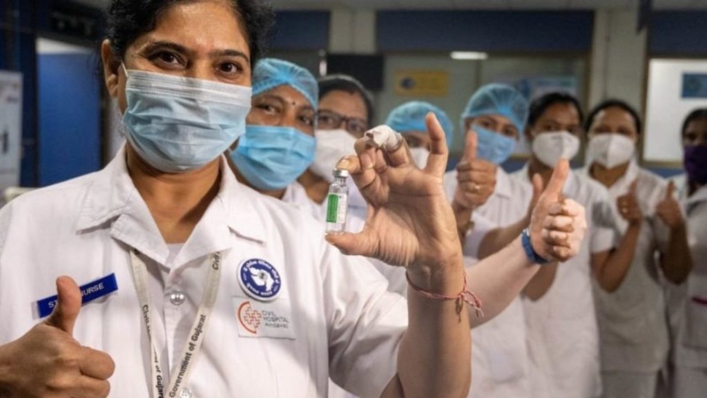 Health workers holding vaccine vials