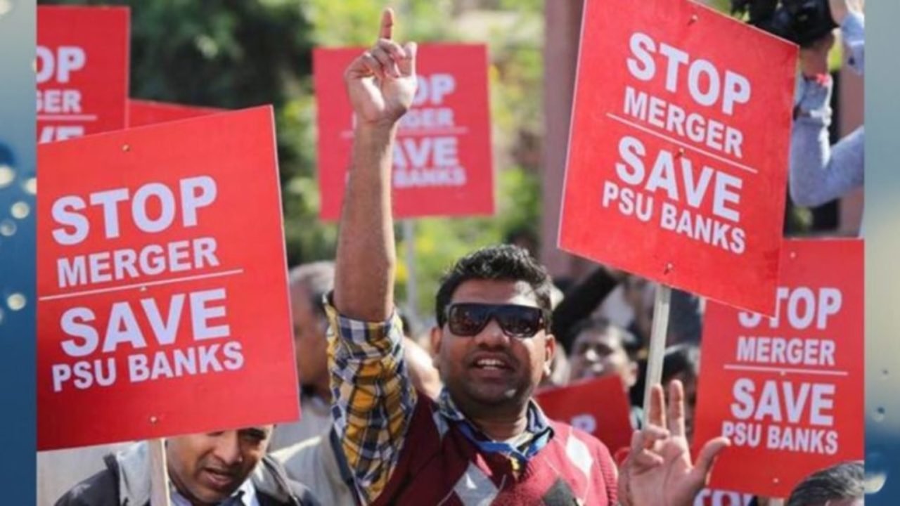 People protesting while holding posters reading "STOP MERGER SAVE PSU BANKS"