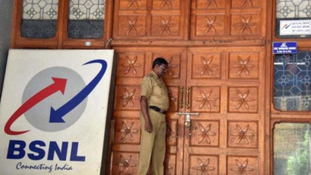 A policeman standing by the door to a BSNL building