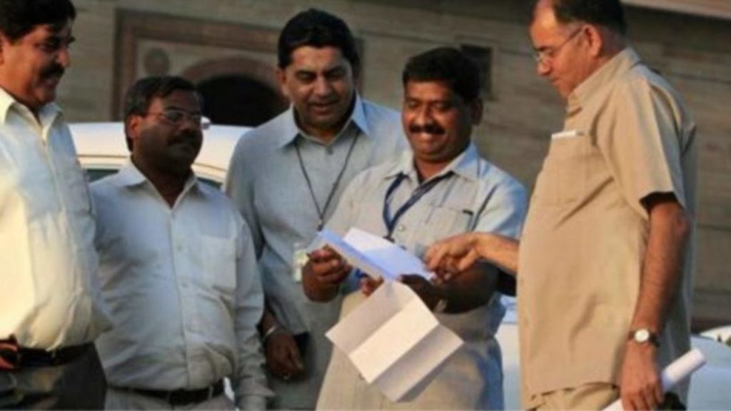 Govt employees holding and discussing documents