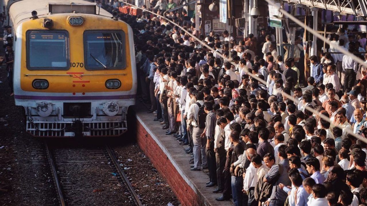 Overcrowded railway station platform waiting to board a train