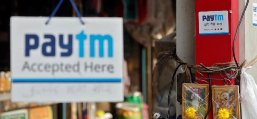 A Paytm tag reading Paytm Accepted Here hanging in front of a shop