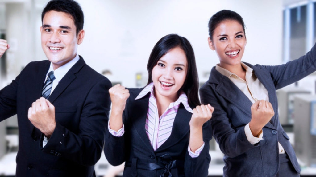 Stock image of office employees posing with fists in the air