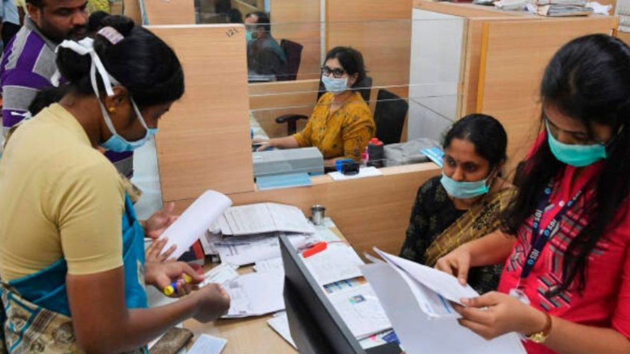 Customers at a desk inside a bank